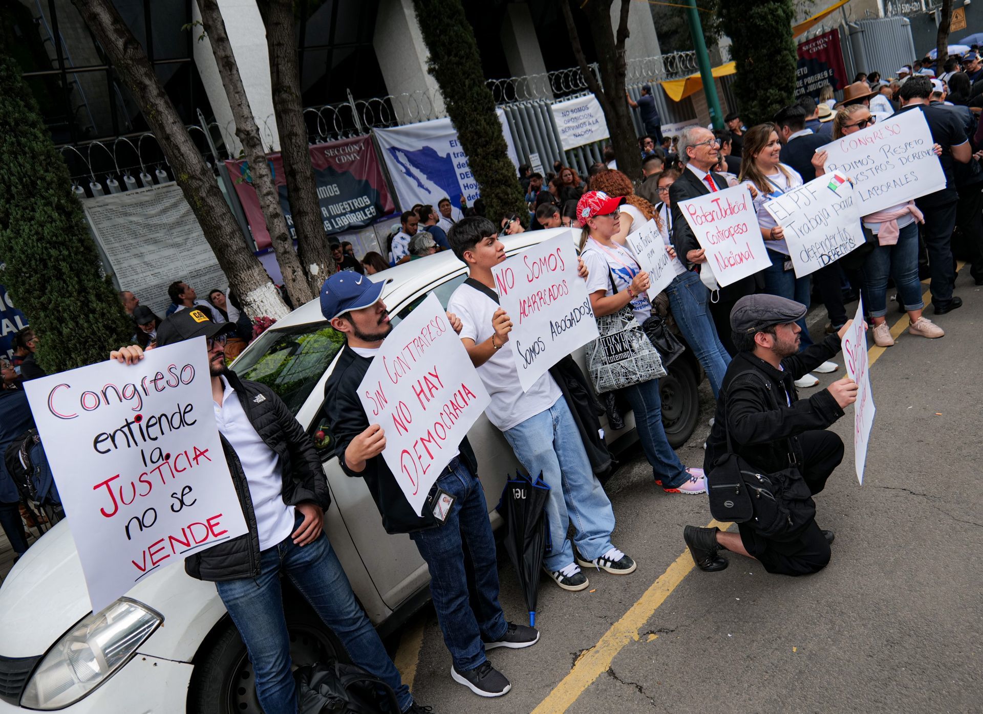 Varios trabajadores del Poder Judicial de la Federación (PJF) sosteniendo carteles frente a la sede Prisma durante el paro de labores en protesta contra la reforma propuesta por el Ejecutivo Federal. (Cuartoscuro)